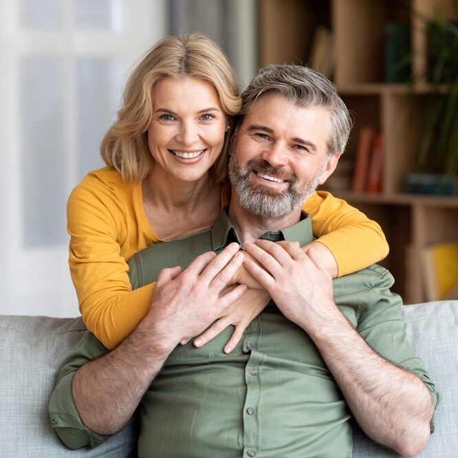 Home Page Dental Implants in Columbia Couple on the couch